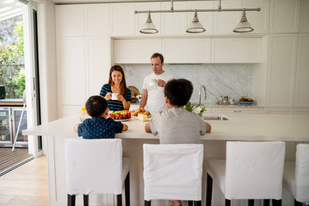 Family preparing breakfast Family preparing breakfast. Family eating together breakfast. brolga stock pictures, royalty-free photos & images