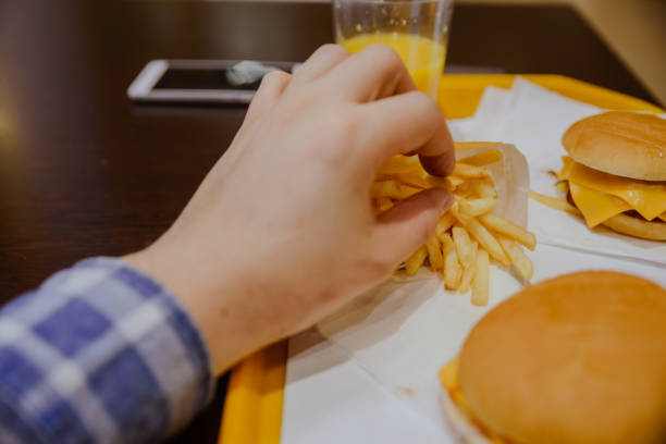 istock man eat french fries 913504462