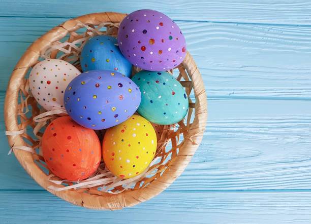 istock Easter eggs basket on blue wooden 913513948