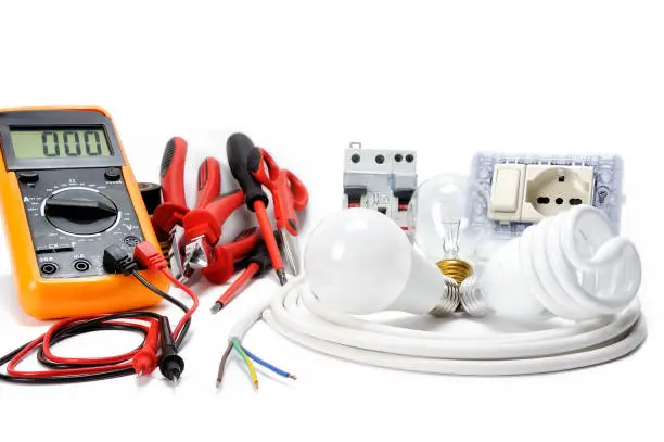 Photo of Close-up of working tools and components of the electrical system on white background.