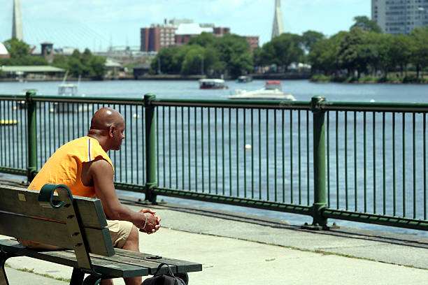 Man looking out at the water stock photo