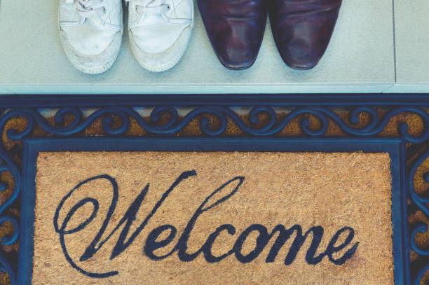 istock Welcome mat at the open front door. 913518718
