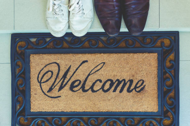 istock Welcome mat at the open front door. 913518722