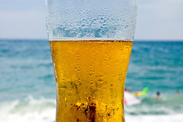 istock A cold glass of beer on the beach 91351887
