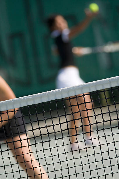 istock tennis net with two female players 91351951