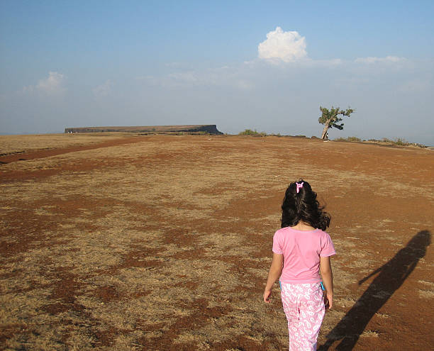 Young girl walking into Eternity, India  ringlet stock pictures, royalty-free photos & images