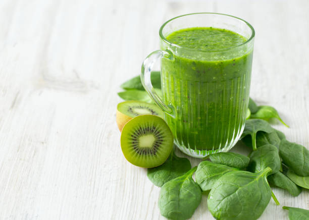 istock fresh green smoothie on wooden surface 913521700
