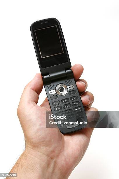 Hält Ein Gsmmobiltelefon Stockfoto und mehr Bilder von Am Telefon - Am Telefon, Arbeiten, Bedienungsknopf