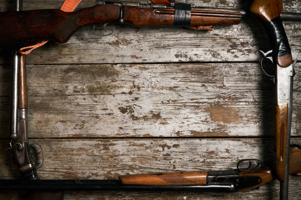 istock Hunting guns frame on wooden table 913522368
