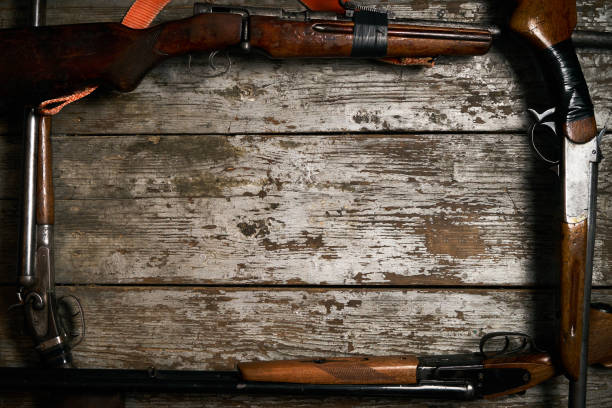 istock Hunting guns frame on wooden table 913522434