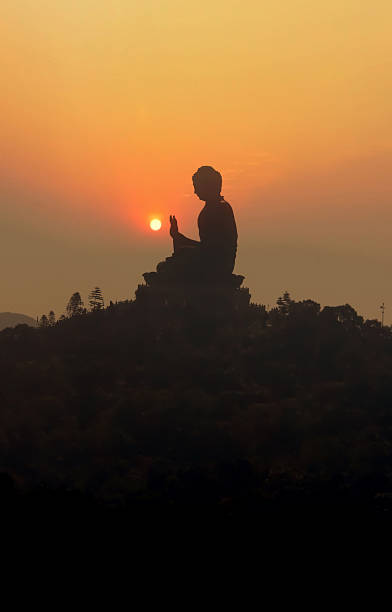 istock Buddha statue at sunset holding flaming sun in hand 91352483