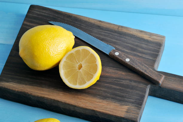 istock whole lemon and half of lemon with knife 913528414
