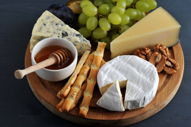 istock different types of cheese with mold, honey grapes and nuts 913534856