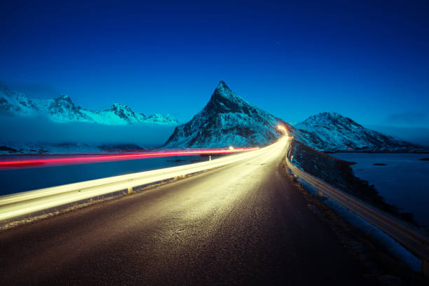 istock Olstind Mount and car light. Lofoten islands? spring time, Norway 913535100