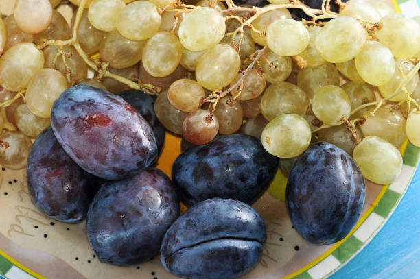 istock fruit plate plums and grapes in a plate 913535188