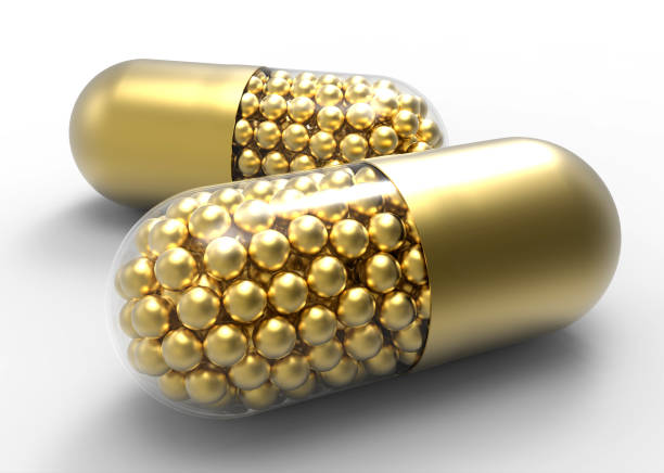 golden capsule with gold drugs balls on white - perscription capsule frame pill imagens e fotografias de stock