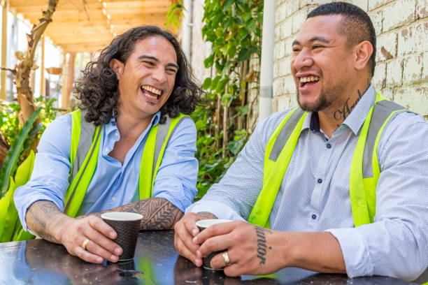 Construction Worker Men in High Vis Vests Having a Coffee Break Construction Worker Men in High Vis Vests Having a Coffee Break pacific islander ethnicity stock pictures, royalty-free photos & images