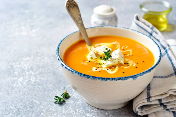 Thick pumpkin soup with feta cheese and thyme stock photo