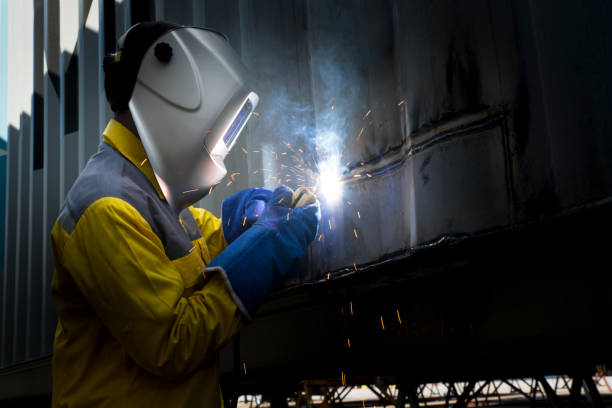 istock Industry worker with welding steel to repair container structures manufacture workshop. Container maintenance industry. 913542228