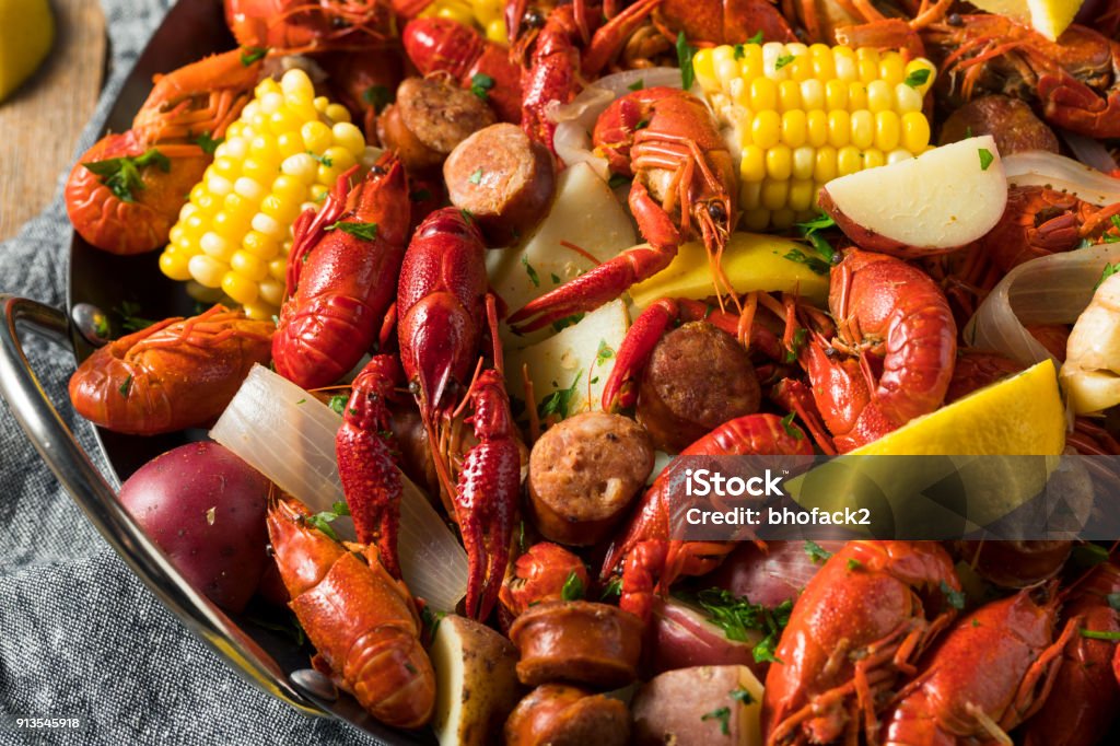 Homemade Southern Crawfish Boil Homemade Southern Crawfish Boil with Potatoes Sausage and Corn Crayfish - Seafood Stock Photo