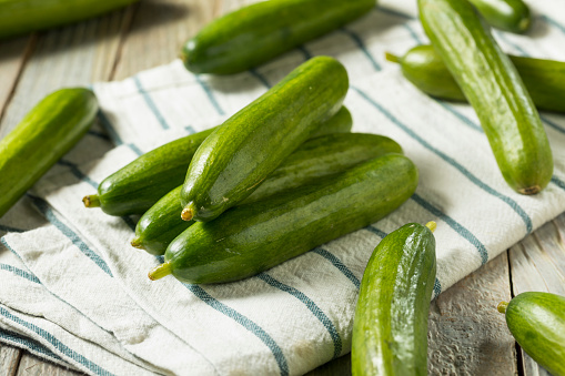 Raw Green Organic Persian Cucumbers in a Pile