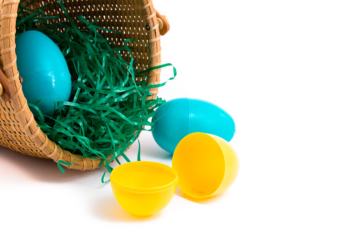 Easter basket with plastic eggs isolated on a white background.