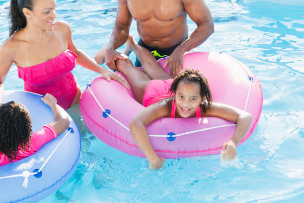 istock Family having fun at water park lazy river 913552682