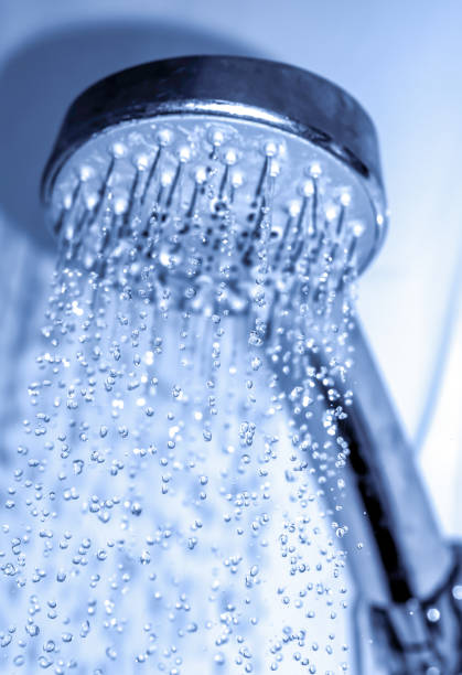 istock Water drops close-up dripping from the shower blue filtered 913553218
