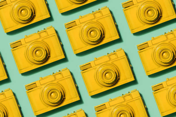 istock Retro yellow cameras on green background 913556906
