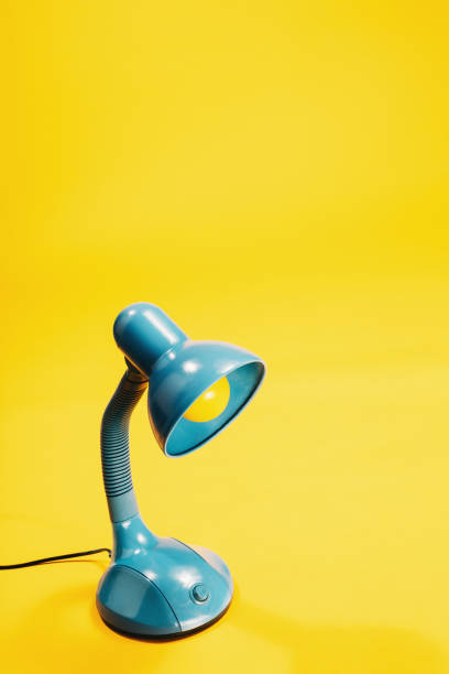 istock Sky-blue desk lamp on yellow background. 913559938