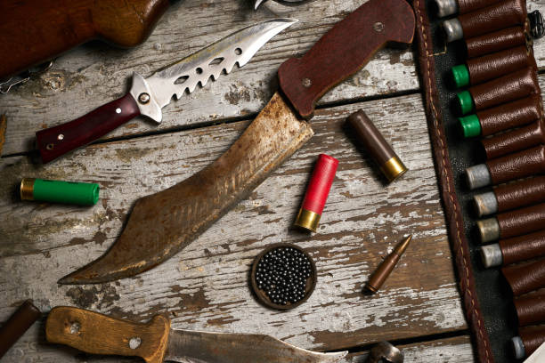 istock Hunting equipment on wooden background 913560358