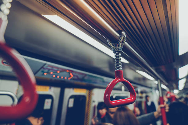 People were traveling By holding the handrails on the subway in Hong Kong stock photo