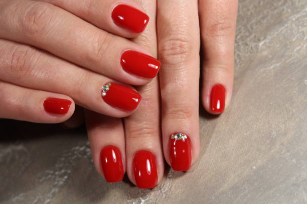 istock Manicured nails colored with red nail polish 913568304