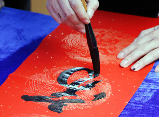 istock Chinese traditional custom: writing Spring Festival couplets. 913573782