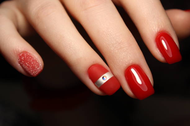 istock Manicured nails colored with red nail polish 913573810
