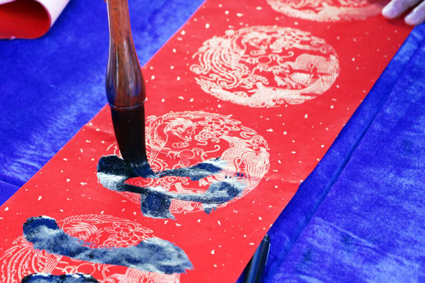 istock Chinese traditional custom: writing Spring Festival couplets. 913573982
