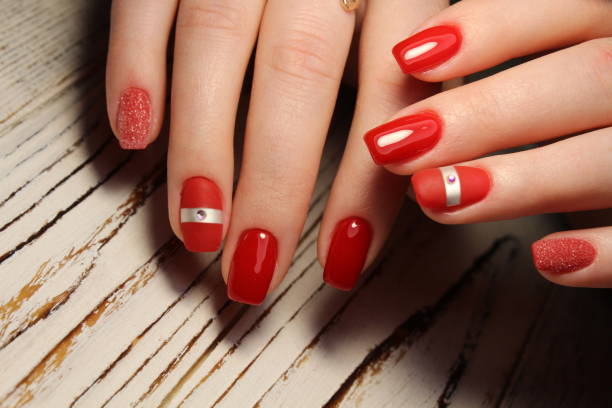 istock Manicured nails colored with red nail polish 913574522