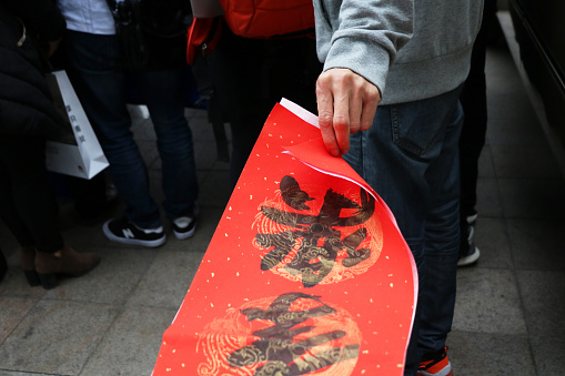 Zhongshan,Guangdong,China-January 26,2018:Every year, in China,the Spring Festival is approaching, people wrting Spring Festival couplets in order to prepareing for the lunar Spring Festival. For the festive air, people like using gold powder in writing words. Spring Festival couplets in Chinese means the good luck things. It’s said that, it can bring fortune and can look as a good omen.