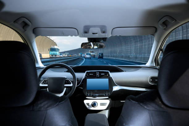 cockpit of driverless car driving on highway viewed from rear seat. - interior de transporte imagens e fotografias de stock