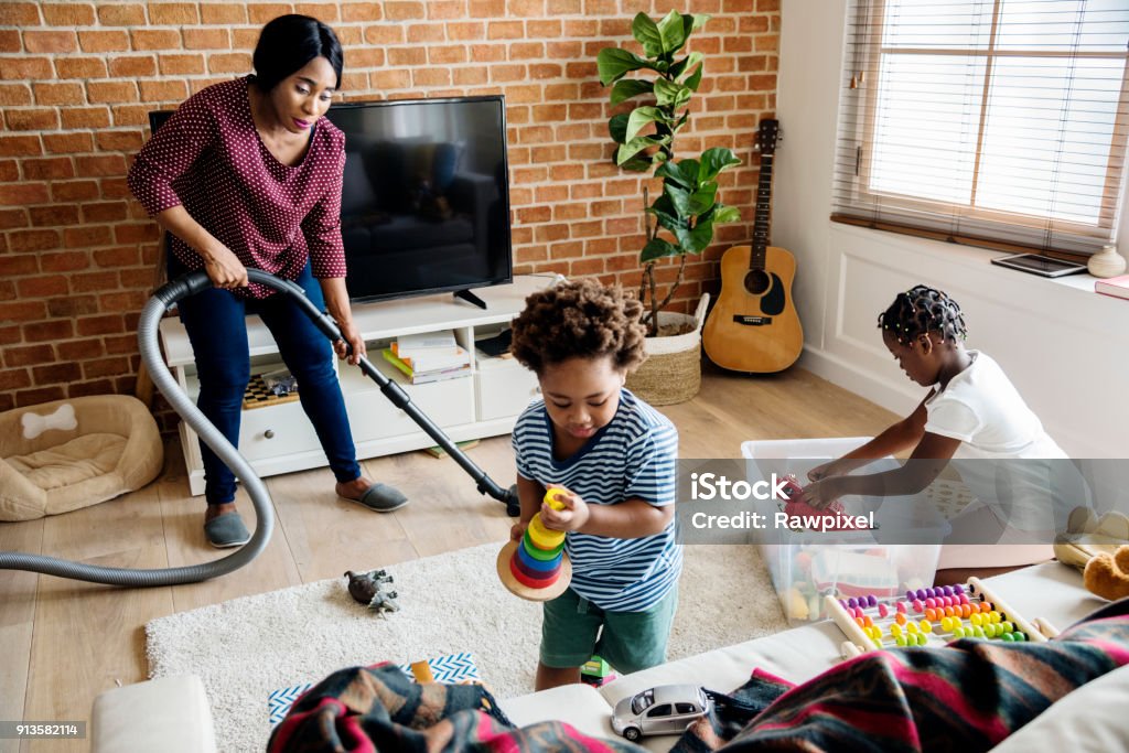 Black family cleaning the house together Cleaning Stock Photo