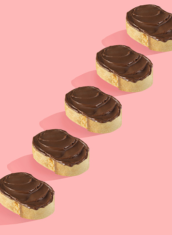 Chocolate spread on breads on a pop style background