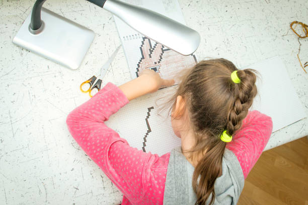 istock The girl draws felt-tip pens in a notebook in the box. 913595870