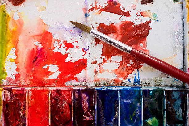 istock Artists watercolour paint palette and brushes in use close up 91360342