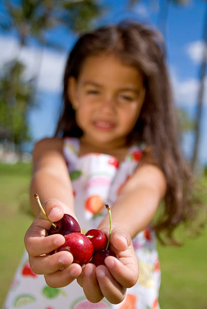 Lots of cherries on table on sunset. Cherry with drops water, background. Cherry background. Beautiful Red berries background. Delicious Cherry berry background. Bunch of red cherries in bright light.