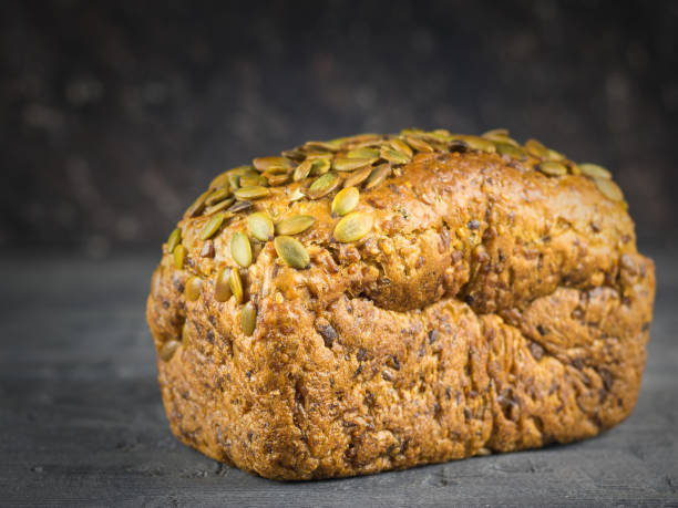 istock A loaf of whole-grain bread, on black rustic table. 913610136