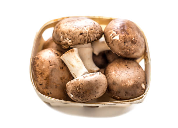 istock Mushrooms in a basket isolated on a white background. 913610486