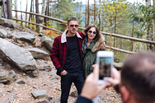 istock guy and girl are posing on camera 913619304