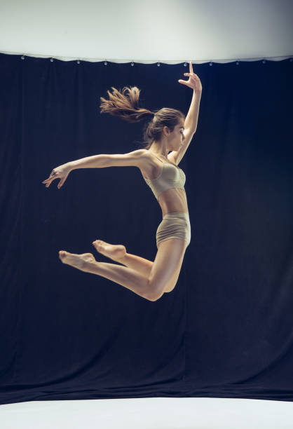 istock Young teen dancer on white floor background 913622968