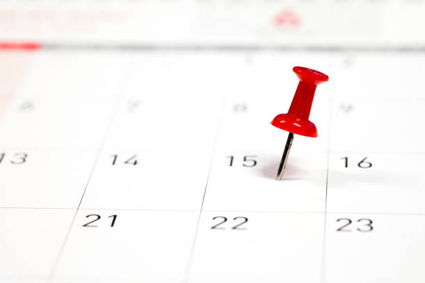 istock Embroidered red pins on a calendar on the 15th with selective focus 913623506