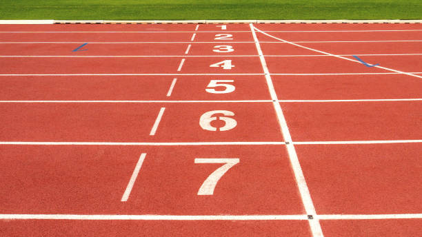 istock red running track on athletic stadium background texture 913625690